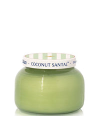 Green candle with a white and green striped lid on a white background