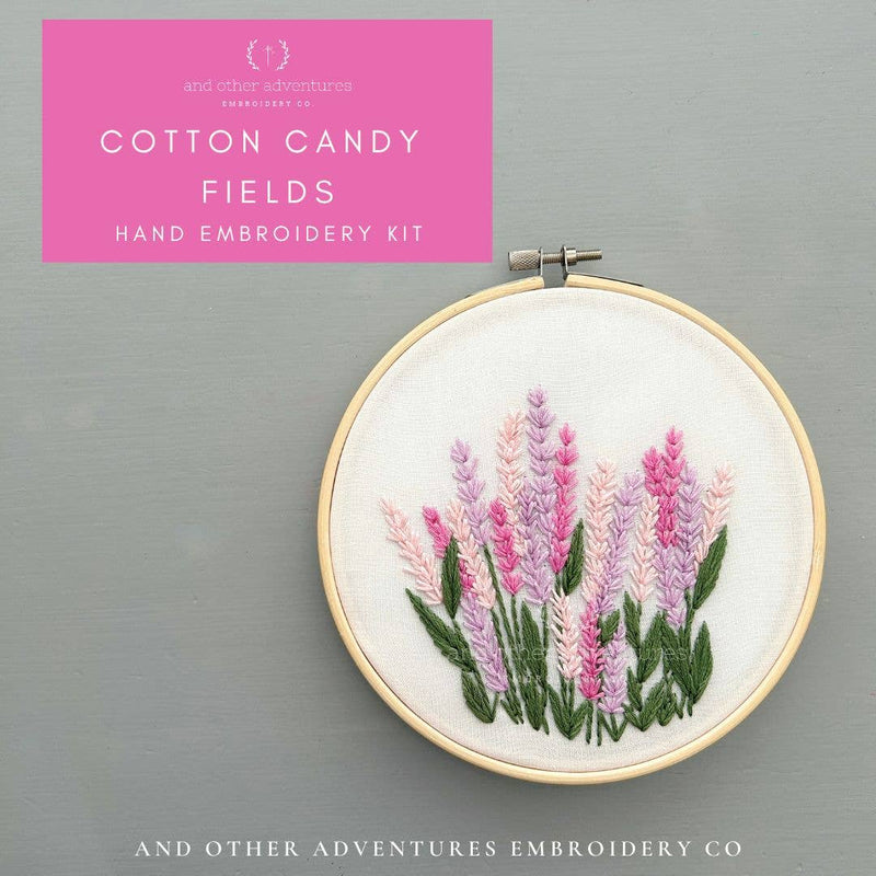 Hand embroidery kit with embroidered flowers in a hoop on a gray background