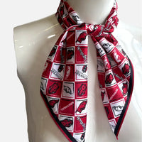 A square scarf with a red and white University of Arkansas Razorbacks pattern, tied around the neck of a white mannequin torso.
