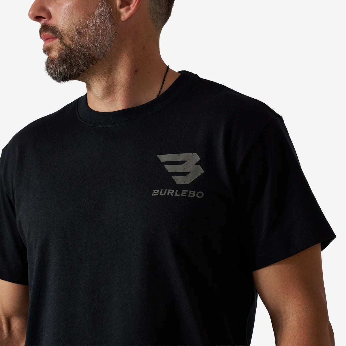 Person wearing a black t-shirt with Burlebo logo on a white background