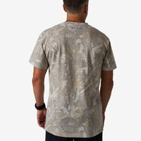 Person wearing a camouflage-patterned t-shirt on a white background