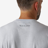 Gray t-shirt with 'Burlebo' logo on the back, worn by a person.
