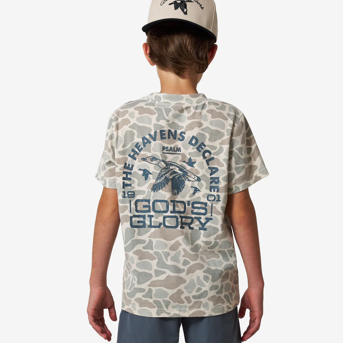 Child wearing a camouflage t-shirt with text and graphics on a white background
