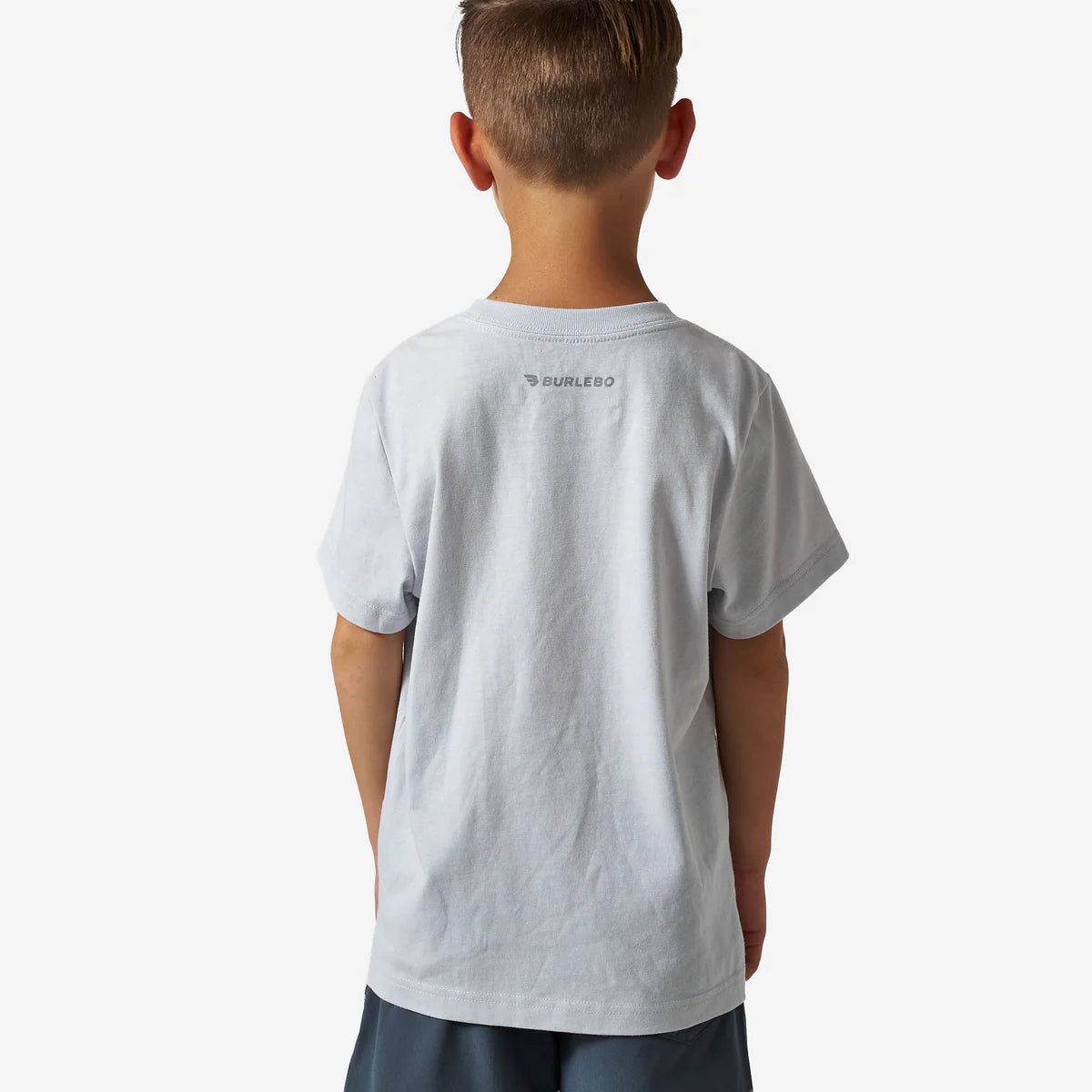 Child wearing a gray t-shirt with a brand logo on the back against a white background