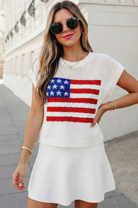 Woman wearing a white crochet top with an American flag design and a white skirt.