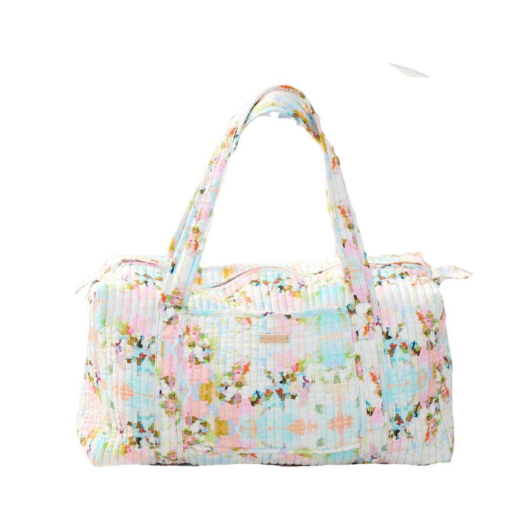 Floral patterned duffel bag on a white background
