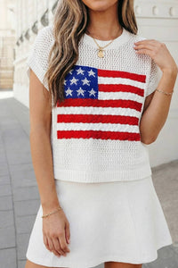 Woman wearing a white sleeveless top with an American flag design and a white skirt.