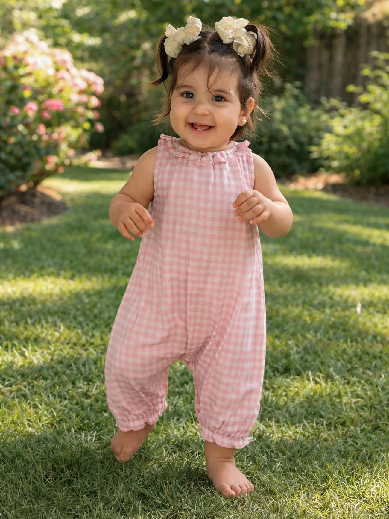 Child wearing pink checkered outfit
