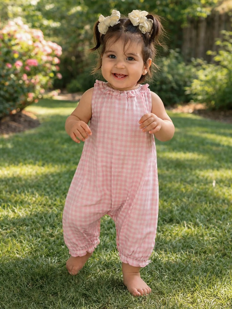 Child wearing pink checkered outfit