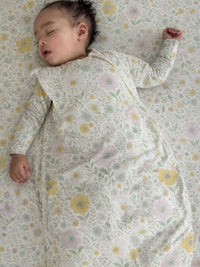 Baby sleeping on a floral-patterned blanket