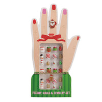 A festive nail set displayed on a hand-shaped stand. The set includes multicolor holiday-themed nail wraps and matching small jewelry pieces, with a green base labeled 'FESTIVE NAILS & JEWELRY SET'.