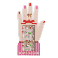 Festive nails and jewelry set in a hand-shaped box with red and pink accents.