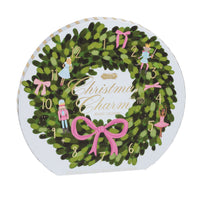 Circular Advent calendar with Christmas wreath design and small illustrated figures.