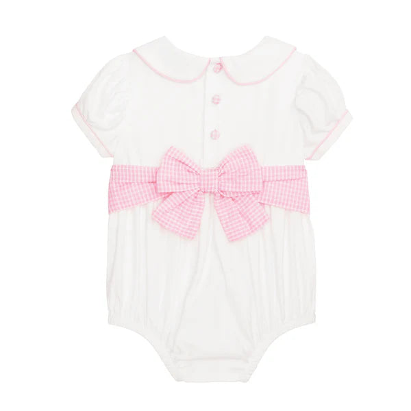White baby romper with pink bow and trim on a white background