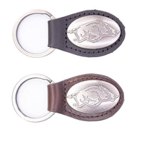 Two keychains with engraved logos on a white background