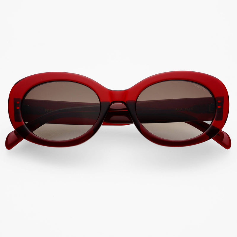 Red sunglasses with dark lenses on a white background