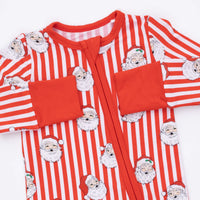 A long-sleeve baby footed sleeper with red and white vertical stripes, featuring a repeating pattern of Santa Claus faces and solid red pocket flaps on a white background.