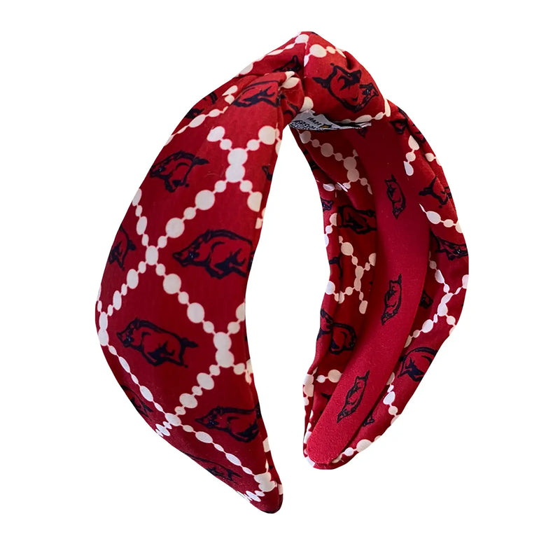 Red headband with black and white pattern on a white background