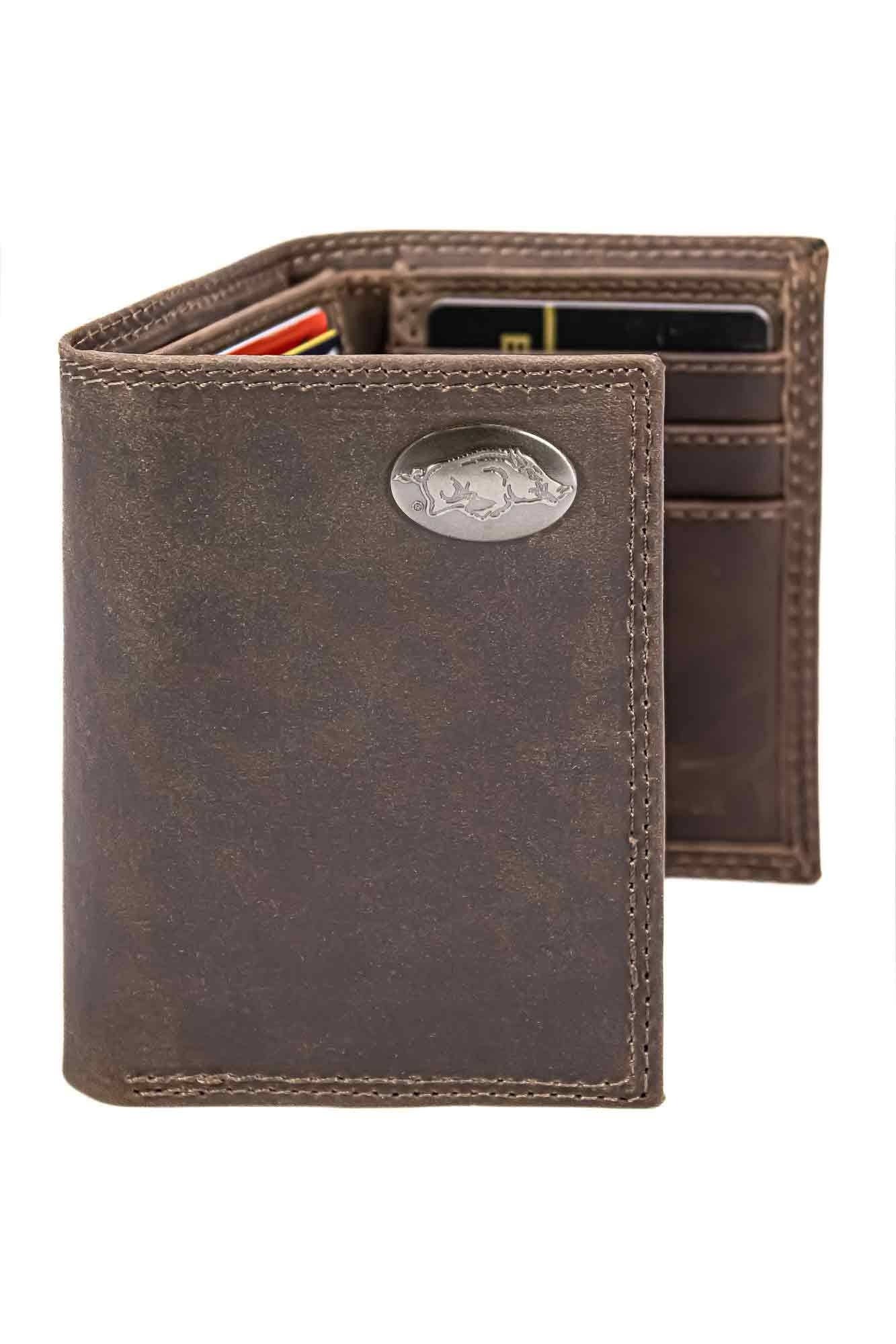 Brown leather wallet with a metallic emblem on a white background