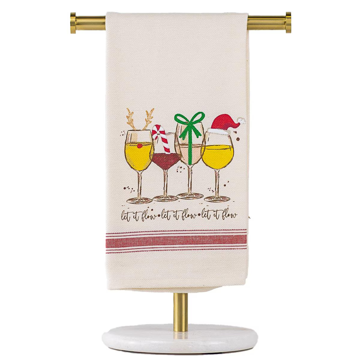 An off-white kitchen towel with a Christmas-themed wine glass illustration and the phrase 'let it flow-let it flow-let it flow' hanging from a gold stand against a white background.