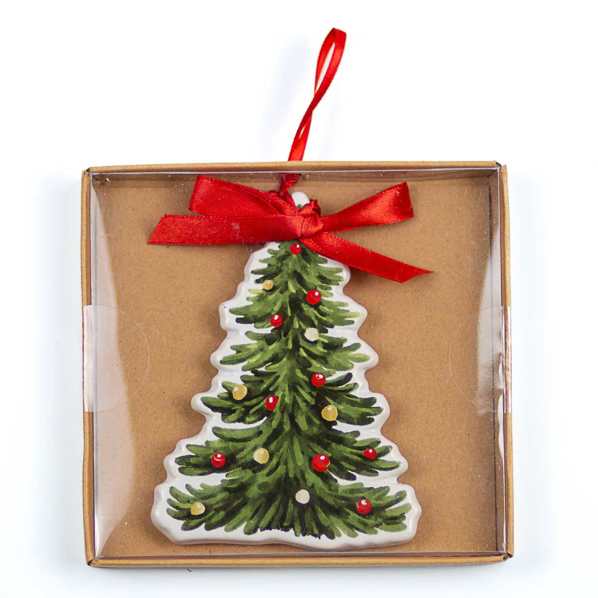 A Christmas tree-shaped ornament with green pine branches, red and gold ornaments, and a red ribbon bow, presented inside a clear-fronted brown cardboard gift box on a white background.