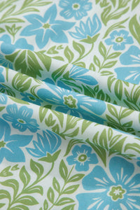 Floral fabric pattern with blue and green flowers on a white background
