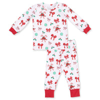 Children's pajama set with red bows and candy cane patterns on a white background