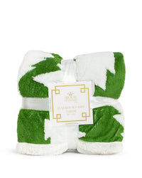 Green and white patterned throw blanket with a brand label on a white background
