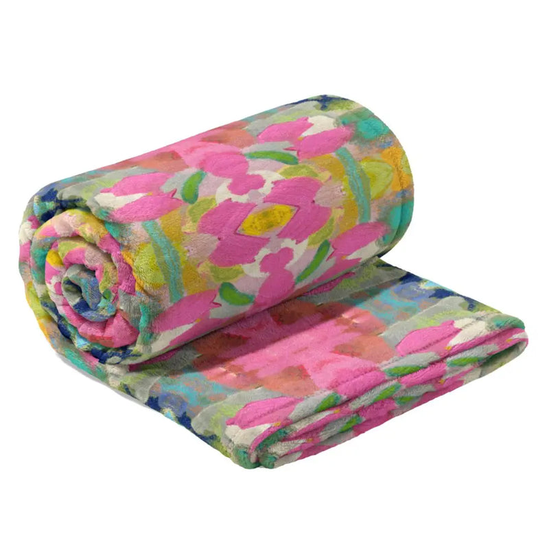 Roll of colorful floral-patterned fabric on a white background