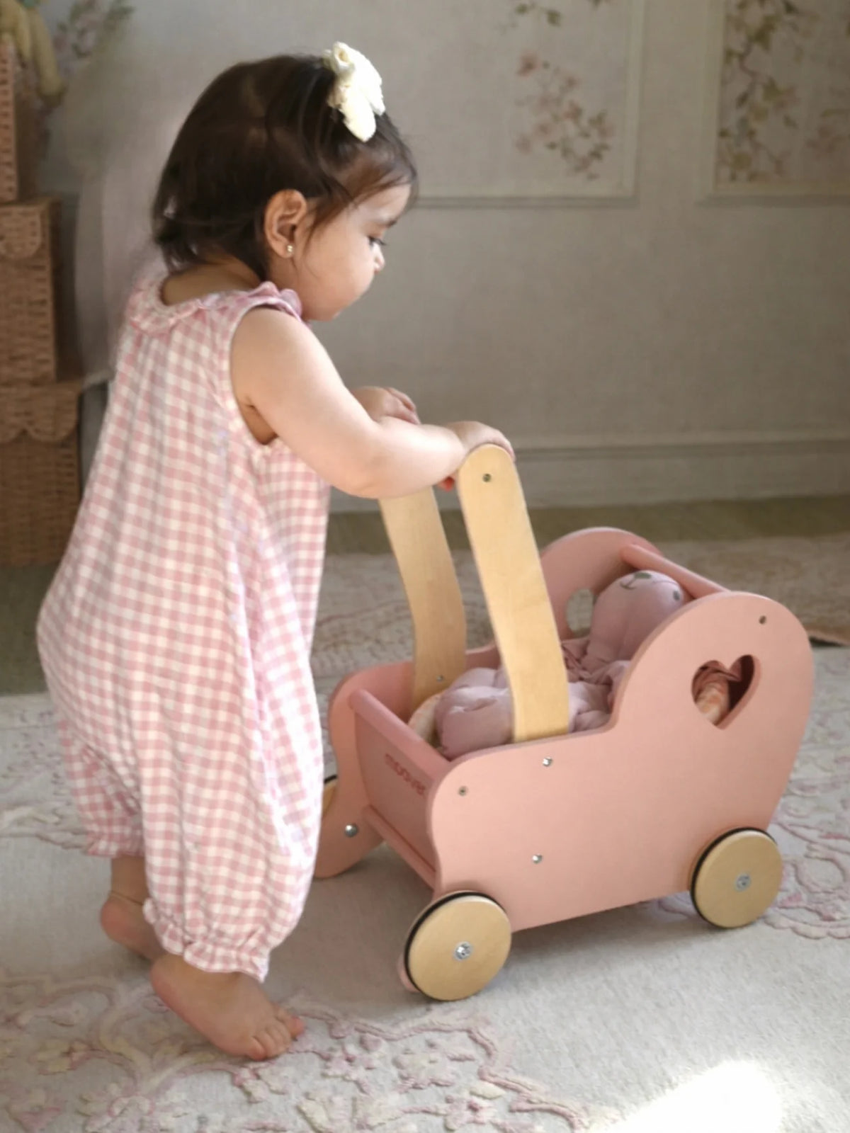 Child wearing pink checkered outfit