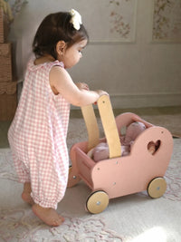 Child wearing pink checkered outfit