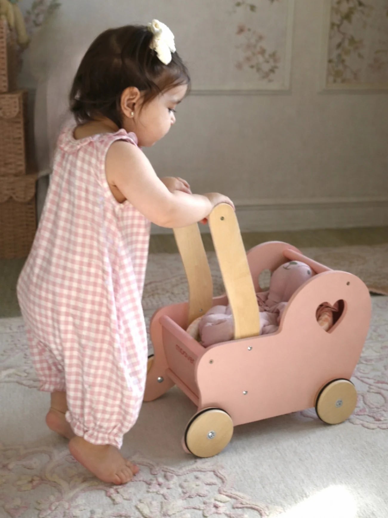Child wearing pink checkered outfit
