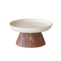 Decorative bowl with wooden base on a white background