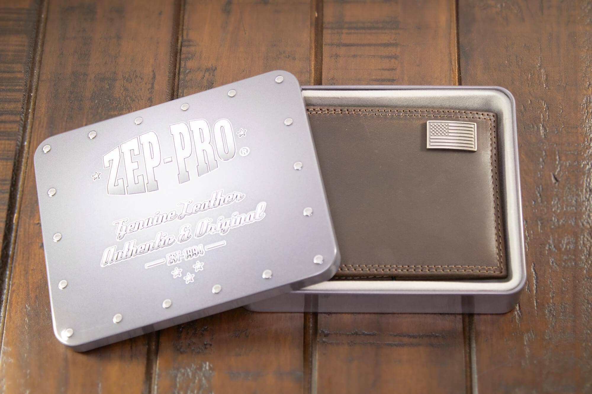 Brown leather wallet in a metal box with 'Zep-Pro' branding on a wooden surface