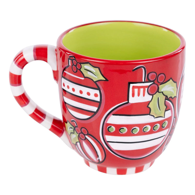 Red ceramic mug with Christmas-themed design on a white background