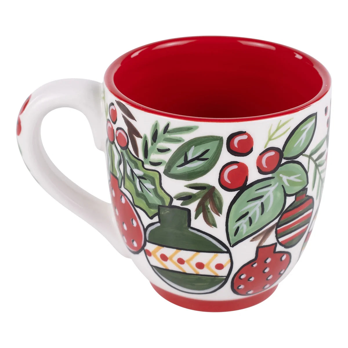 A white ceramic mug with a red interior and exterior base, decorated with a hand-painted folk art style pattern of green leaves, red berries, and a striped ornament.
