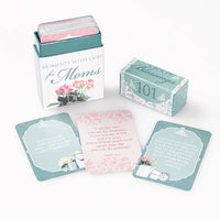 Set of cards with inspirational messages in a decorative box on a white background