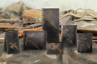 Collection of leather wallets with duck embossing on a camouflage background