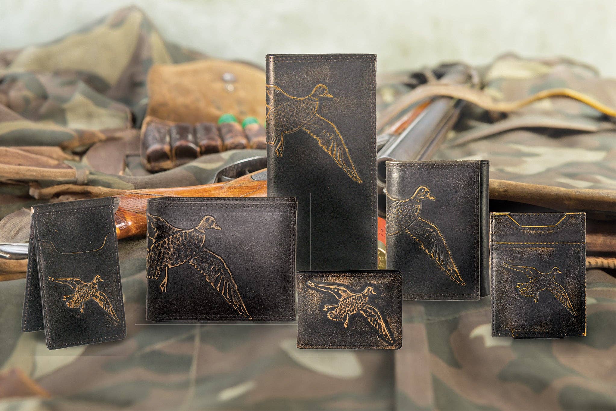 Collection of leather wallets with duck embossing on a camouflage background