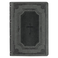 Black leather-bound book with a cross design on a white background