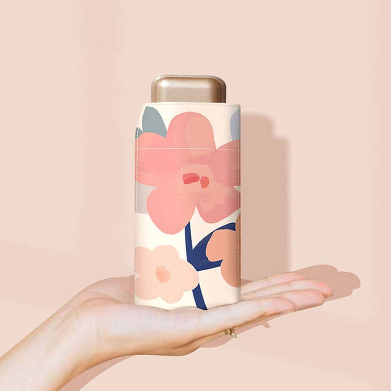 Floral-patterned cylindrical product held in a hand against a beige background