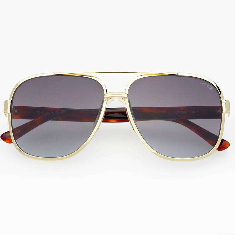 Aviator sunglasses with gold frame and dark lenses on a white background