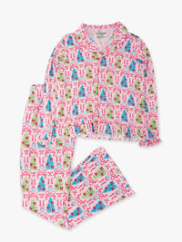 A two-piece women's pajama set featuring a festive Christmas print with pink ribbons, green trees, and blue ornaments on a white background, shown flat against a light gray backdrop.