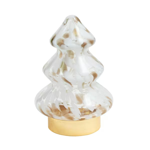 A clear glass Christmas tree-shaped ornament with gold and white marbled swirls, resting on a round gold-colored base against a solid white background.