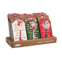 Set of Christmas-themed gift tags with Santa Claus designs in a cardboard holder.