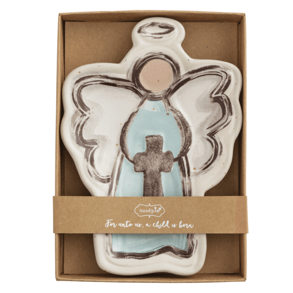 Ceramic angel-shaped dish with a cross in a cardboard box, featuring the brand 'mudpie'.
