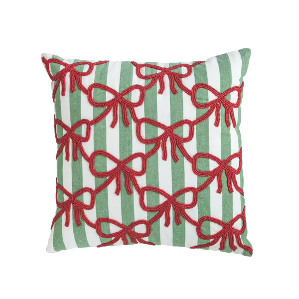 Green & White striped pillow with red beading in a bow shape on a white background 