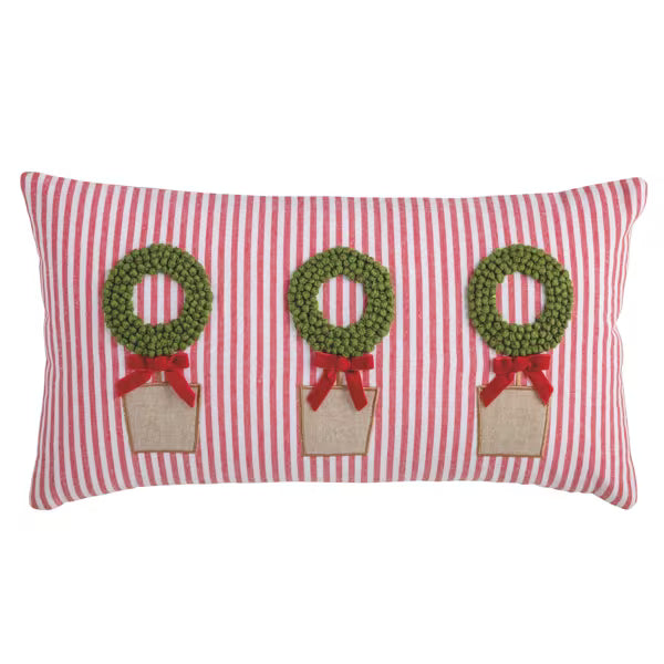 A rectangular red and white striped throw pillow featuring three green pine tree wreaths with red ribbons and burlap boxes on a white background.