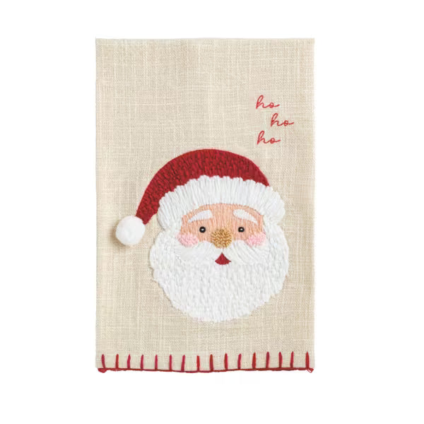 A rectangular beige woven tea towel with a raised embroidered Santa Claus face, red hat, white beard, and red 'ho ho ho' text on a white background.
