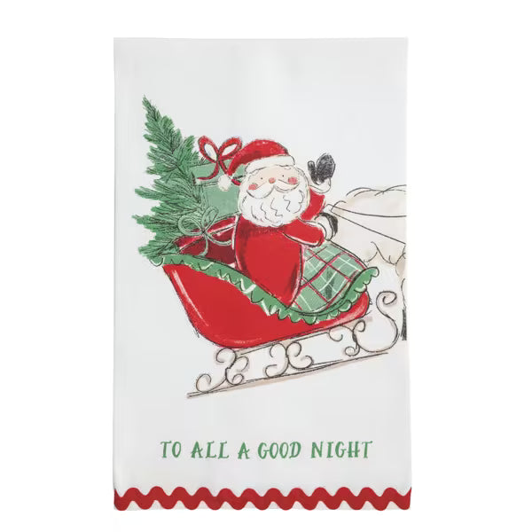 A white kitchen tea towel featuring a vintage-style illustration of Santa Claus in a red sleigh with a green Christmas tree, and the text 'TO ALL A GOOD NIGHT' printed in green near the bottom.